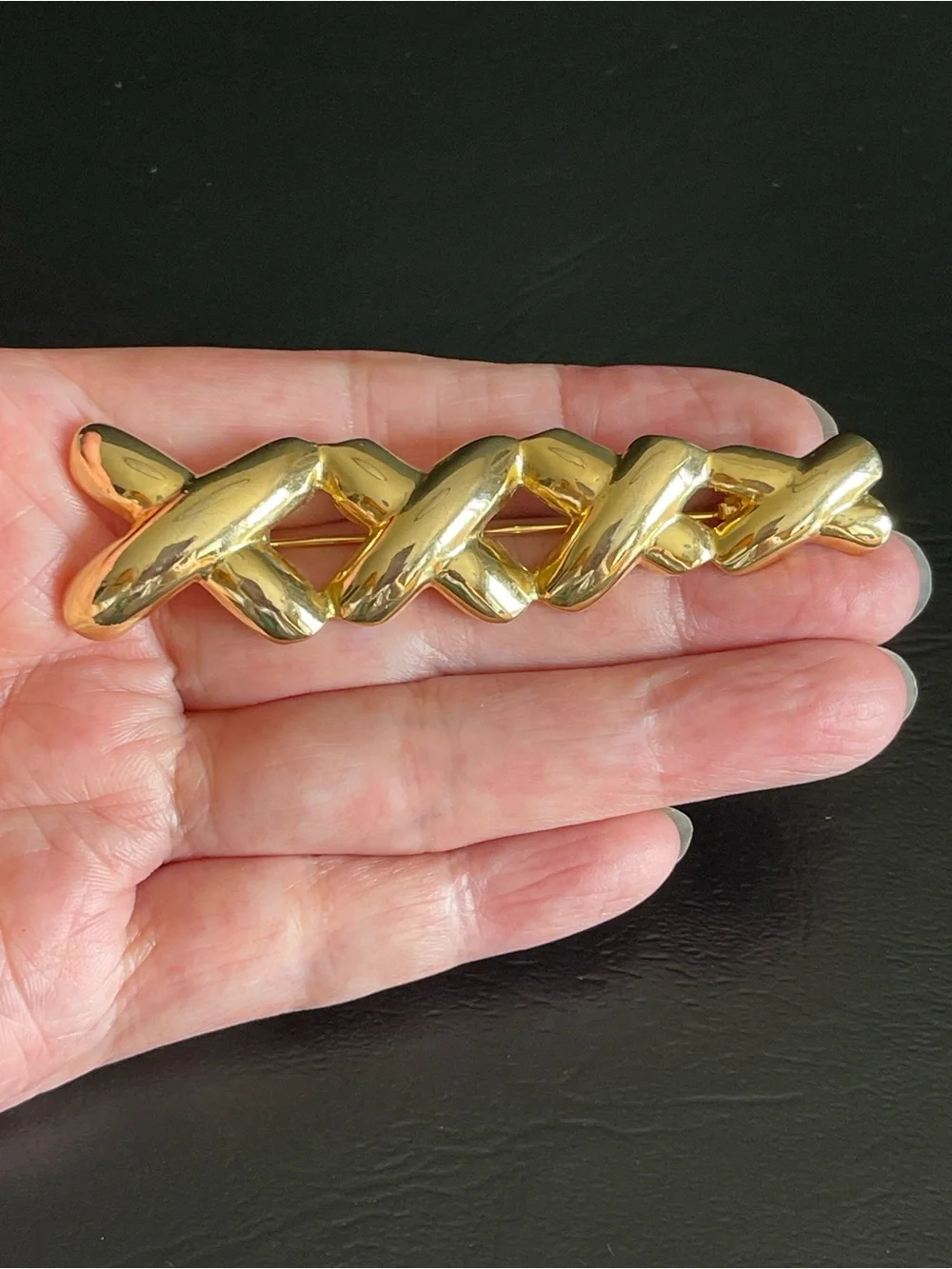 Vintage gold tone xxxx brooch.